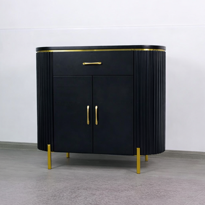 Black cabinet with gold accents on a gray floor and white wall