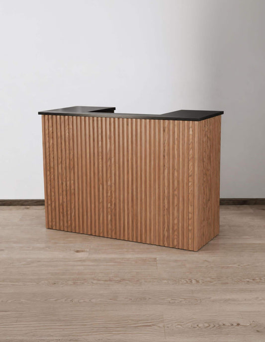 Aria Walnut 59-inch tambour reception desk with a black painted countertop, angled front view